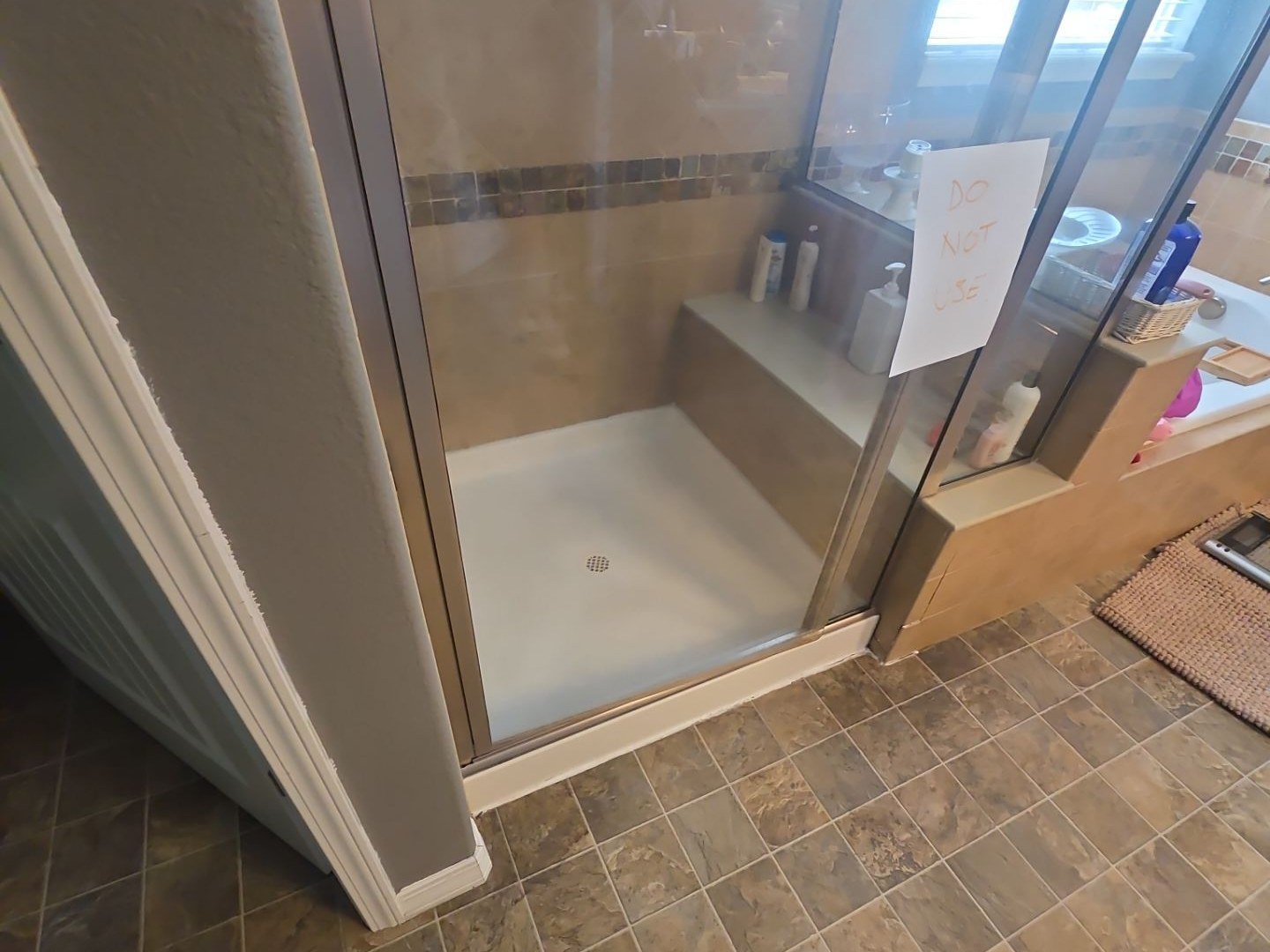 Finished tile and glass shower before the damaged materials were uncovered.