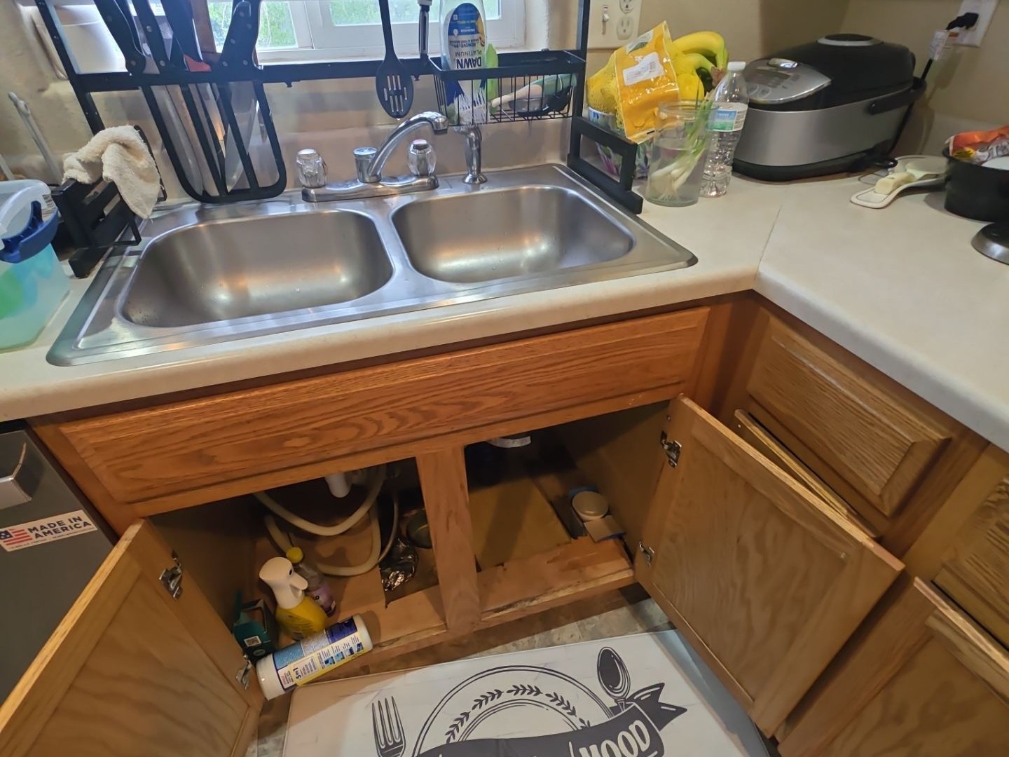 Kitchen sink and cabinet before the hidden moisture damage was exposed.